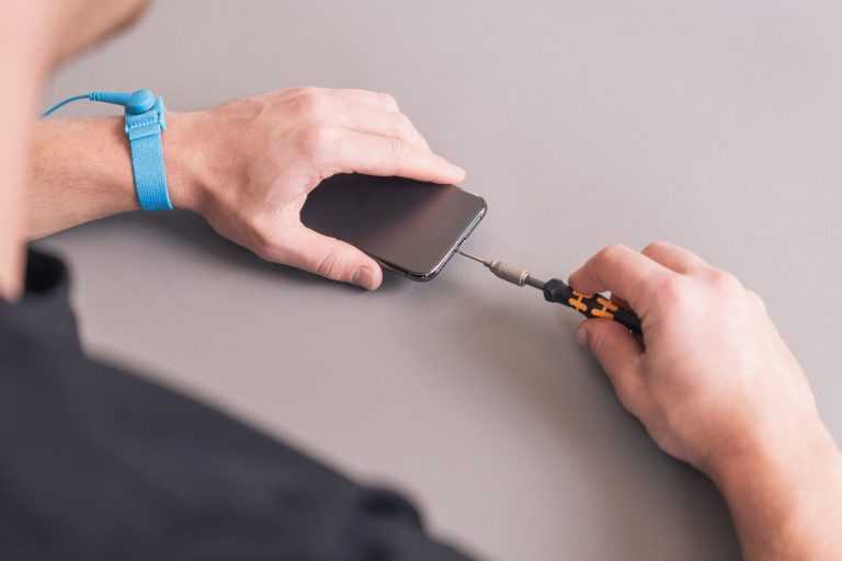 man fixing an iphone