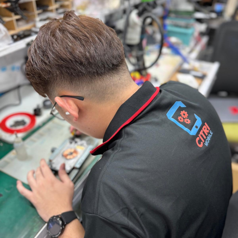 Close-up of a Citri Mobile technician performing board-level Huawei Y7 Pro 2018 repair in Singapore