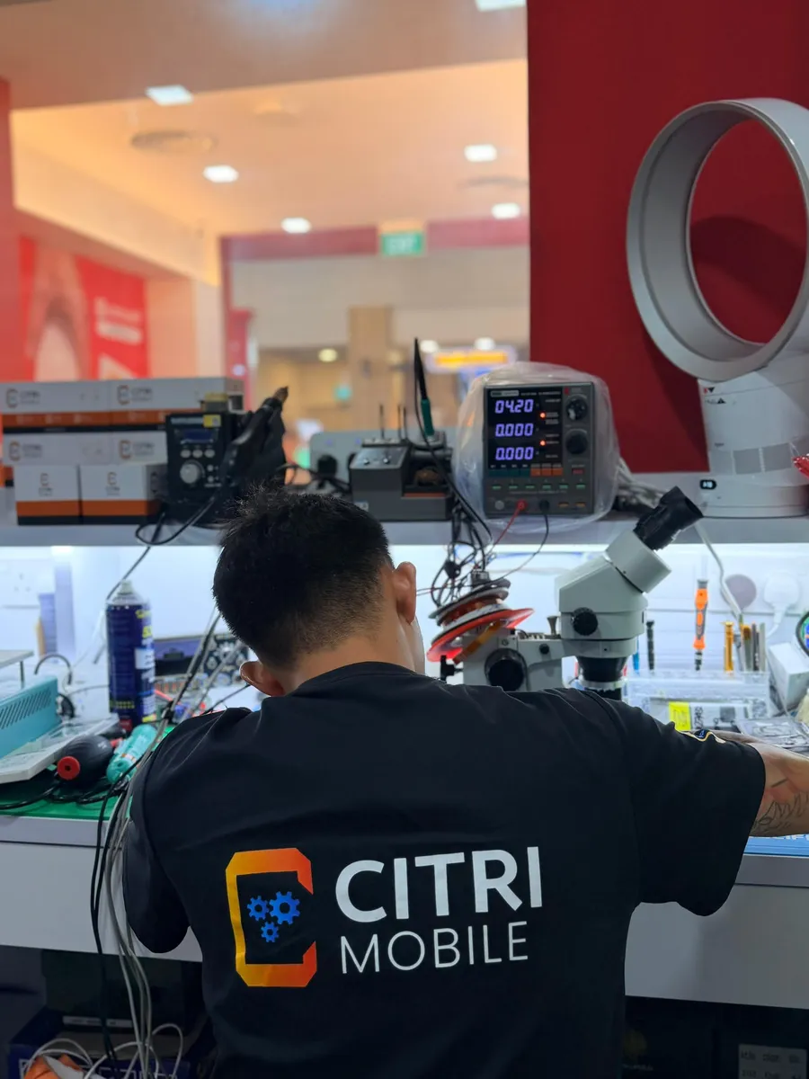 Board-level iPhone repair bench with power supply and soldering stations at Citri Mobile Jurong Point