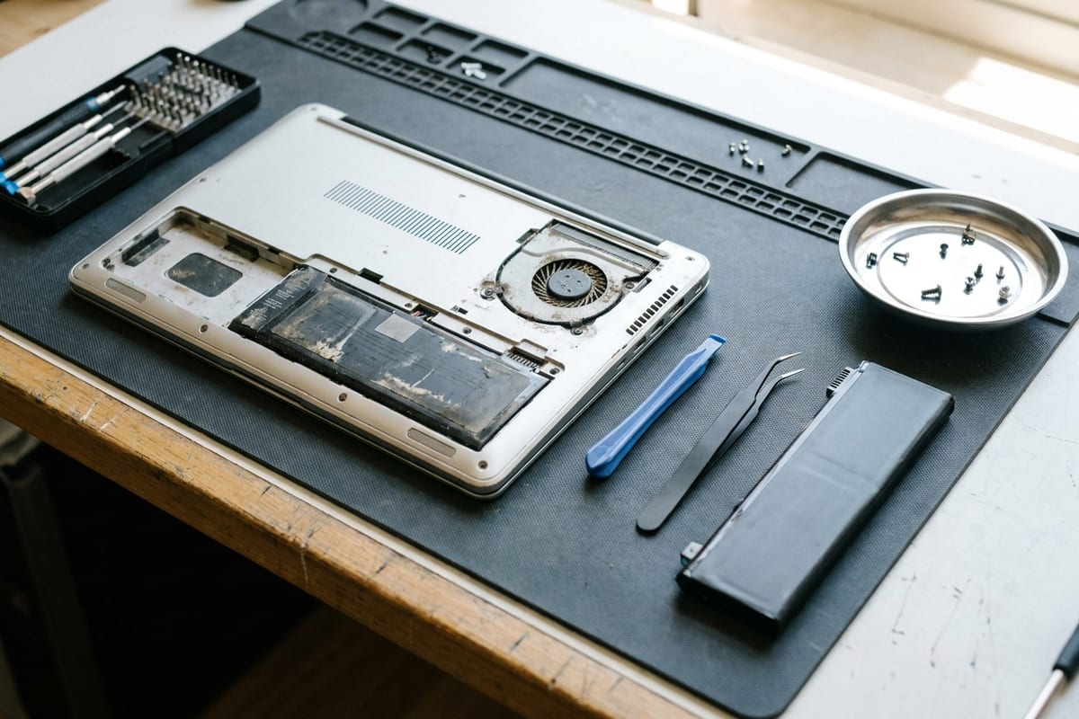 Laptop opened for battery and fan replacement on a Citri Mobile repair bench, as done for Dell laptops